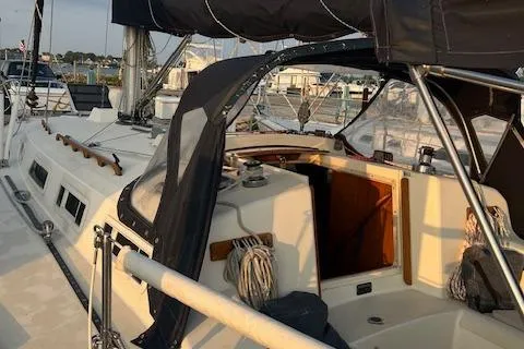 Slide: The Image of 1986 Pearson 36 sailboat with black canopy docked at marina. - 9