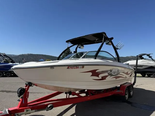 Slide: The Image of 2006 Centurion Enzo SV216 boat on red trailer, parked outdoors under clear blue sky. - 10