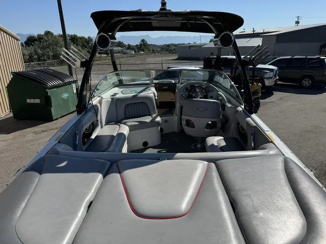 Slide: The Image of 2006 Centurion Enzo SV216 boat interior with seating and dashboard, parked outdoors. - 11