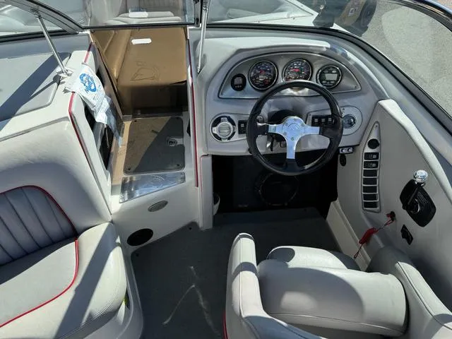Slide: The Image of 2006 Centurion Enzo SV216 boat interior with steering wheel and dashboard controls. - 12
