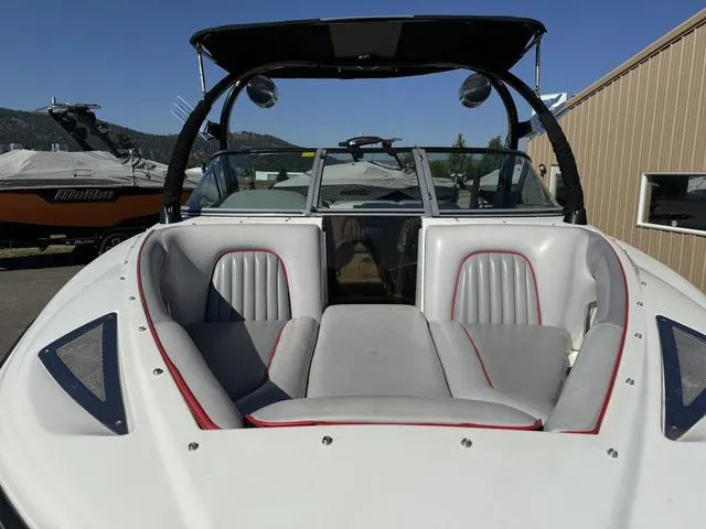 Slide: The Image of 2006 Centurion Enzo SV216 boat with white and gray interior, docked outdoors. - 3