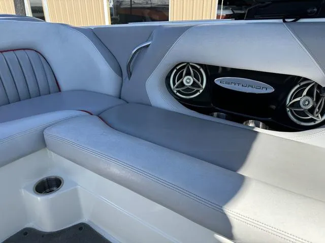 Slide: The Image of 2006 Centurion Enzo SV216 boat interior with gray seating and built-in speakers. - 7