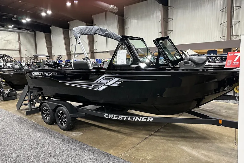 The Image of 2026 Crestliner 2050 Commander boat displayed indoors on a trailer. - 0