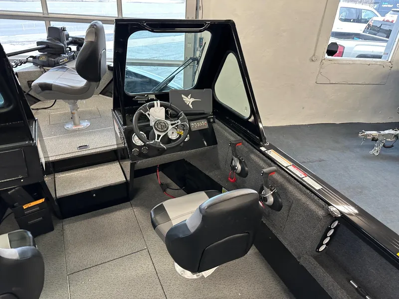 Slide: The Image of Interior of 2025 Crestliner 2050 Commander boat with steering wheel and seating. - 4