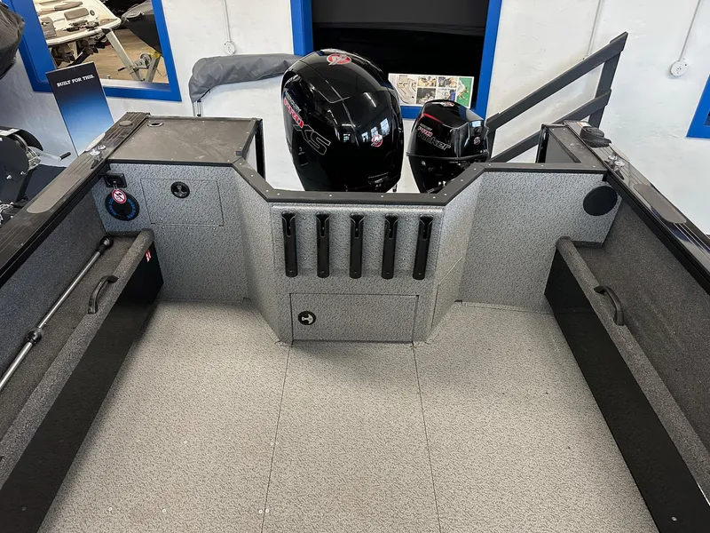 Slide: The Image of 2025 Crestliner 2050 Commander boat interior with storage compartments and motor view. - 6