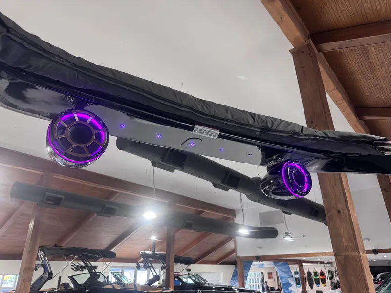 Slide: The Image of 2024 Berkshire 23 RFX DC STS3-93 boat with illuminated speakers in showroom. - 11