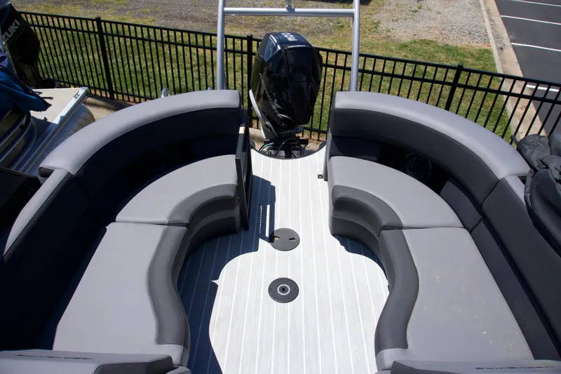 Slide: The Image of 2024 Berkshire 23 RFX DC STS3-93 boat interior with gray seating and outboard motor. - 3