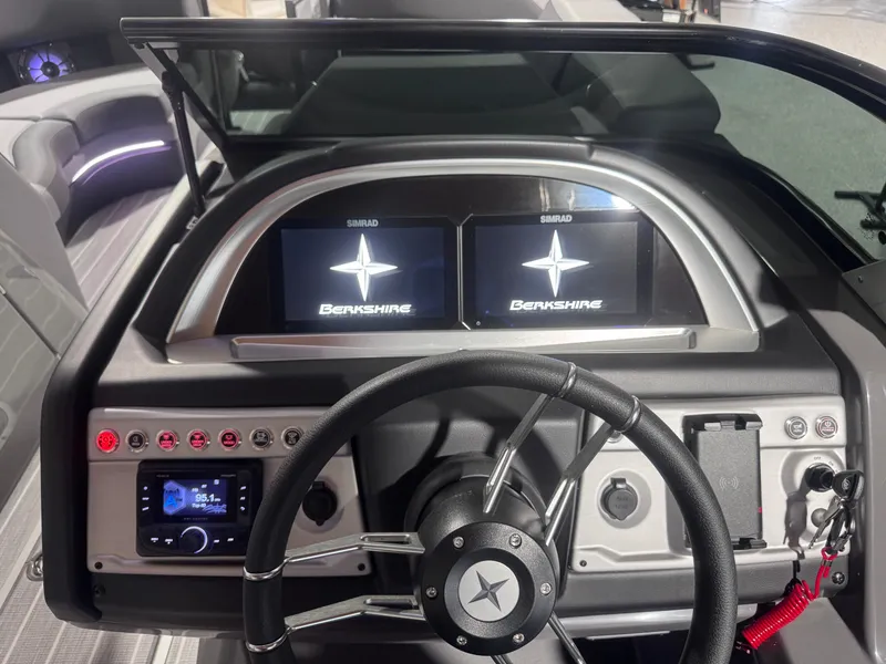 Slide: The Image of 2024 Berkshire 23 RFX DC STS3-93 boat dashboard with dual displays and steering wheel. - 6