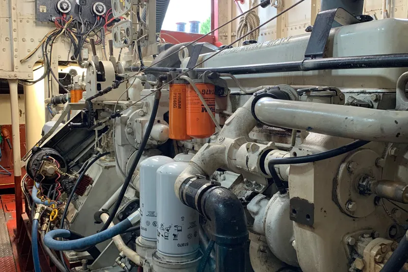 Slide: The Image of Engine room of a 1936 Tugboat Bow Steel, showcasing complex machinery and wiring. - 11