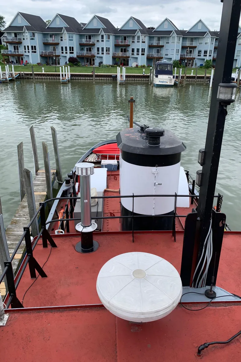 Slide: The Image of Historic 1936 Tugboat Bow Steel docked near waterfront homes. - 14