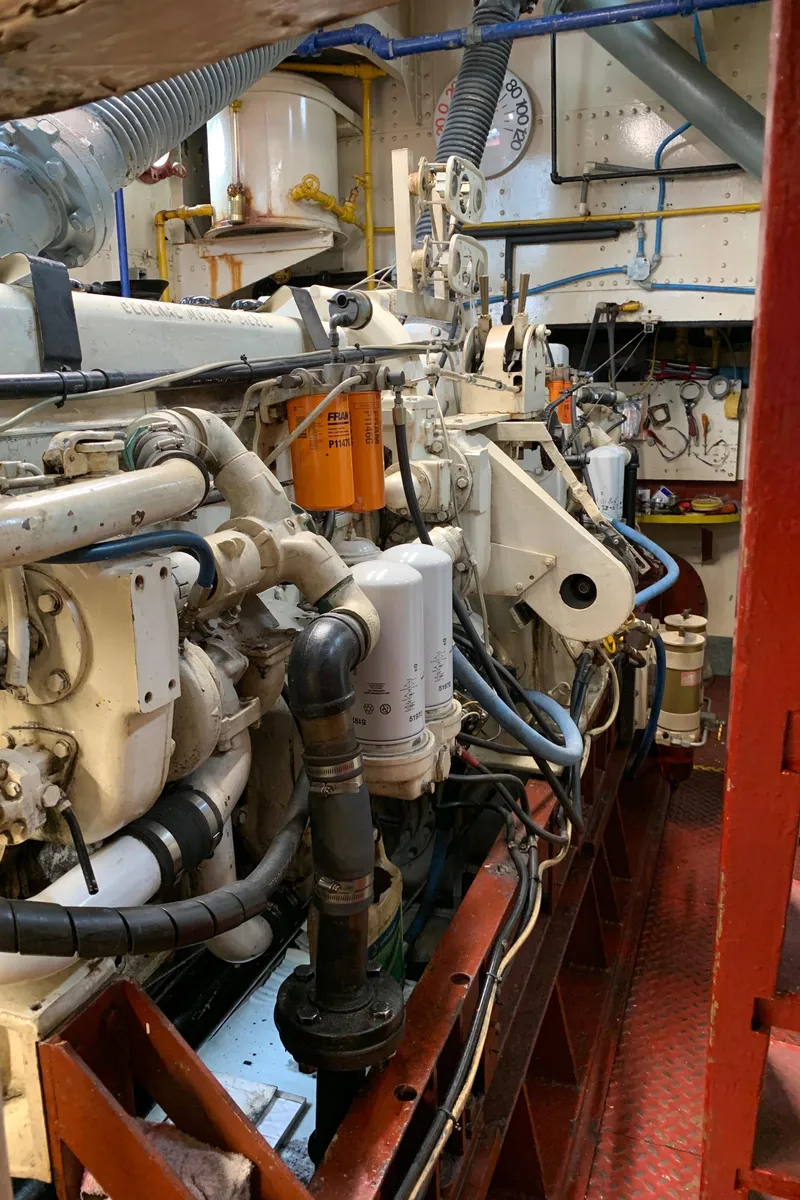 Slide: The Image of Engine room of a 1936 Tugboat Bow Steel, showcasing complex machinery and piping. - 15