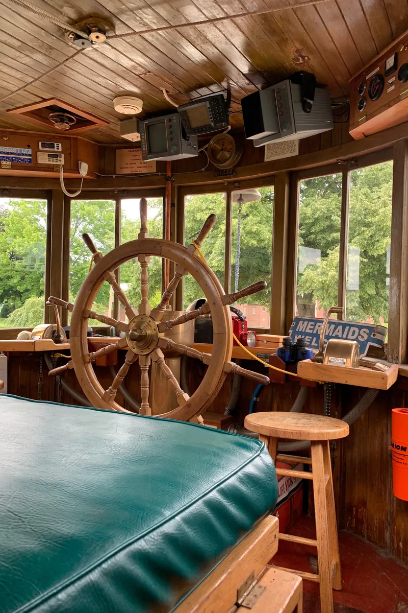 Slide: The Image of Vintage 1936 Tugboat Bow Steel interior with wooden helm and nautical decor. - 21