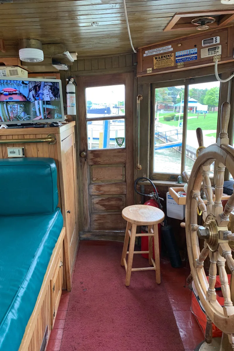 Slide: The Image of Interior of a 1936 Tugboat Bow Steel with wooden helm and vintage decor. - 22