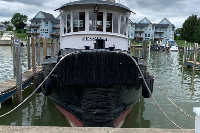 Slide: The Image of Front view of 1936 Tugboat Bow Steel docked in a marina. - 4