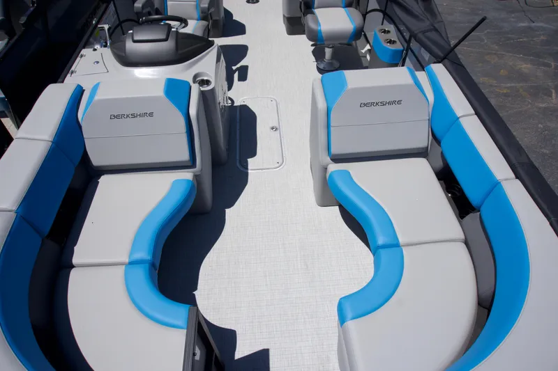 Slide: The Image of 2024 Berkshire 23RFX-STS3 boat interior with blue and gray seating. - 5