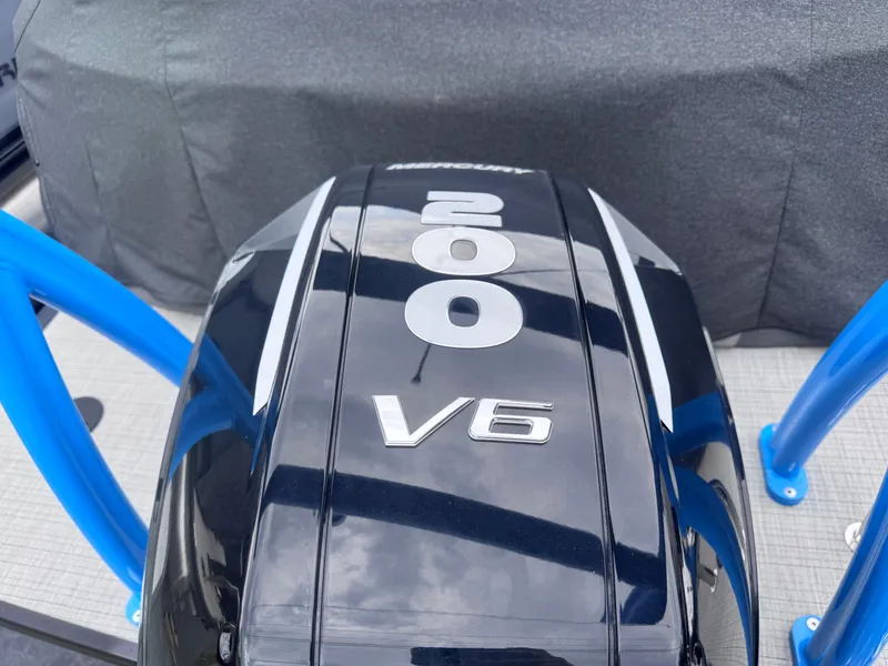 Slide: The Image of 2024 Berkshire 23RFX-STS3 with Mercury 200 V6 engine, blue accents. - 7