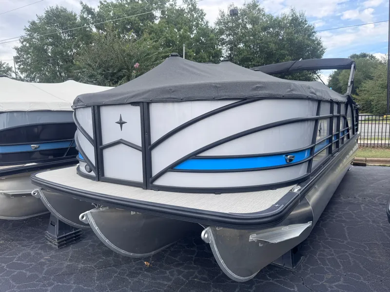 Slide: The Image of 2024 Berkshire 23RFX-STS3 pontoon boat with cover, parked outdoors. - 9