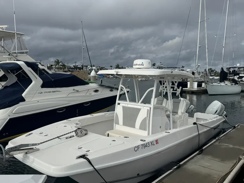 Slide: The Image of 2021 Twin Vee Catamaran docked at marina under cloudy skies. - 0
