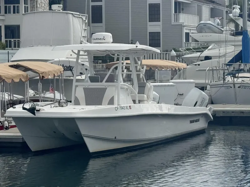 Slide: The Image of 2021 Twin Vee Catamaran docked at marina, featuring sleek design and modern amenities. - 1