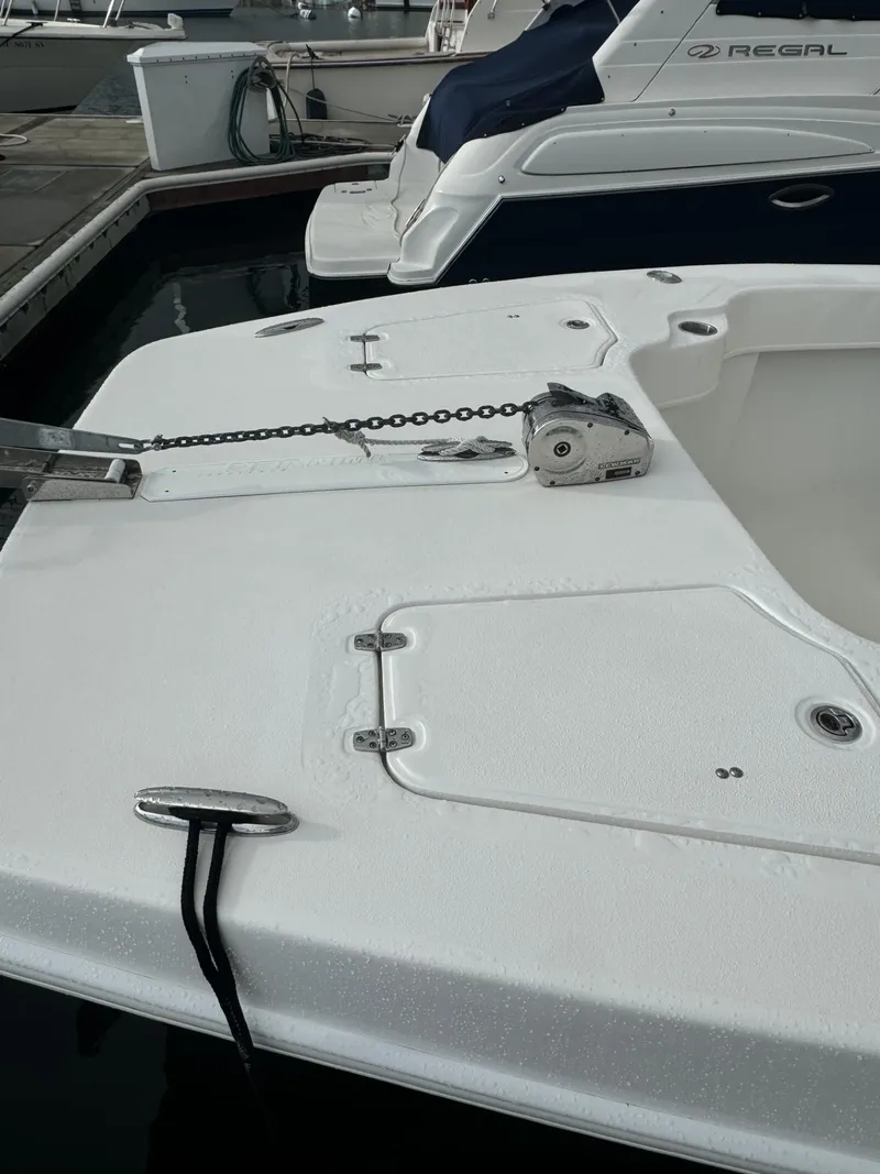 Slide: The Image of 2021 Twin Vee Catamaran docked, showcasing deck details and anchor chain. - 13