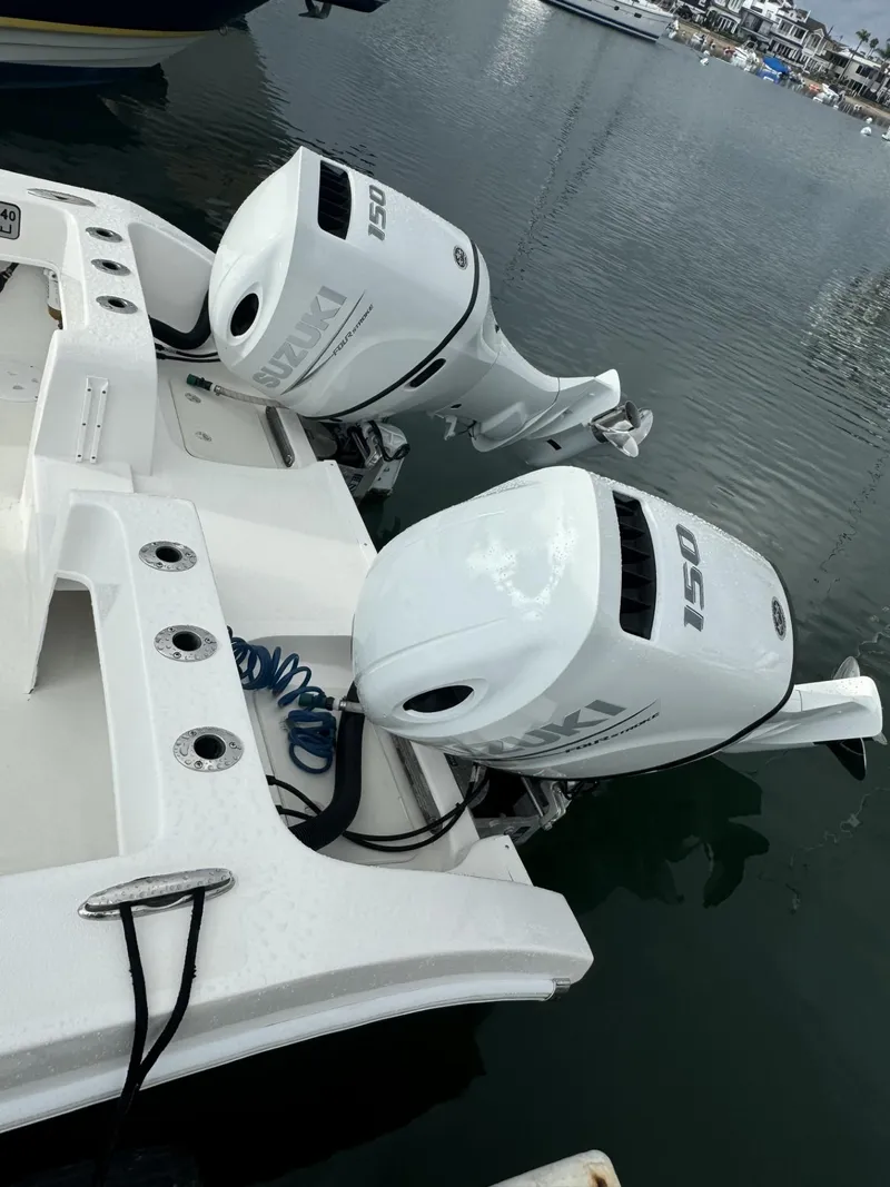 Slide: The Image of Twin Vee 2021 Catamaran with dual outboard motors docked in marina. - 14