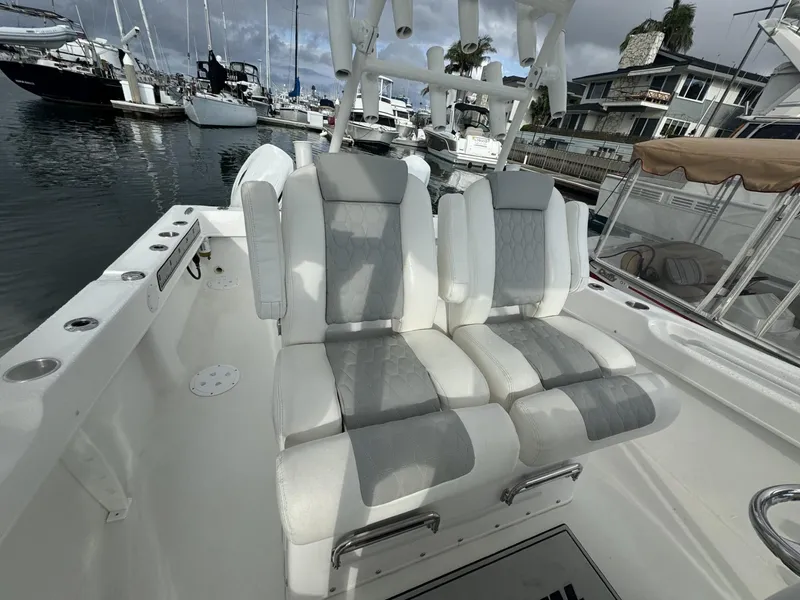 Slide: The Image of 2021 Twin Vee Catamaran with comfortable seating, docked in a marina. - 4