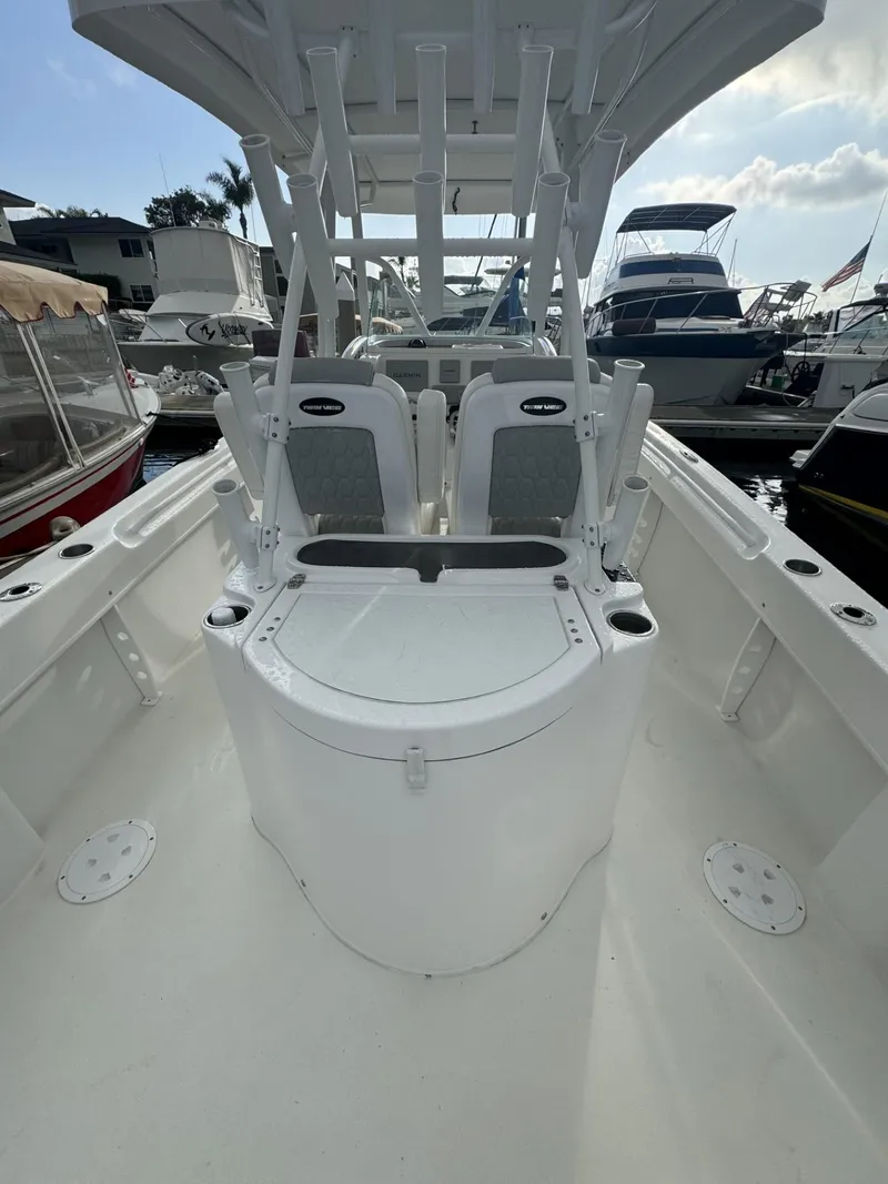 Slide: The Image of 2021 Twin Vee Catamaran boat interior with seating, docked at a marina. - 7