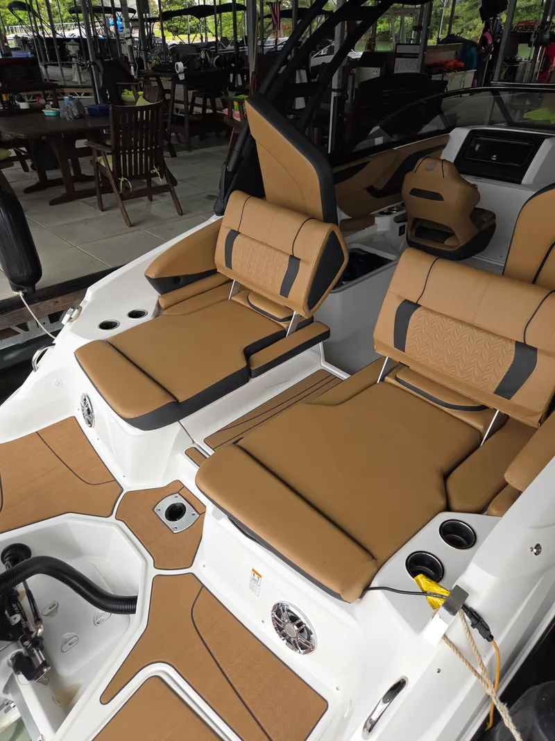 Slide: The Image of 2024 Hurricane SunDeck 2600 OB boat with tan seating and modern design. - 10