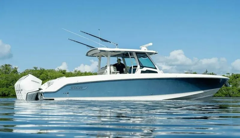 Slide: The Image of 2021 Boston Whaler 380 Outrage boat on calm water, clear sky background. - 0
