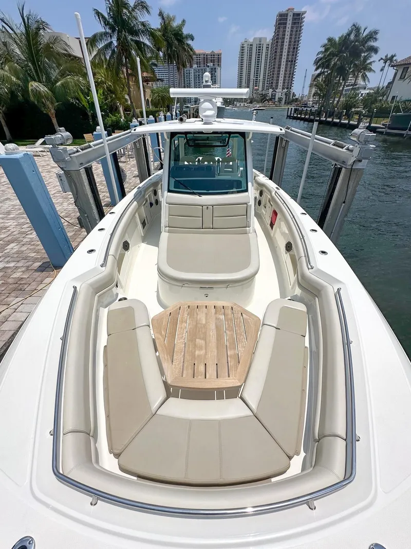Slide: The Image of 2021 Boston Whaler 380 Outrage docked, showcasing spacious seating and sleek design. - 1