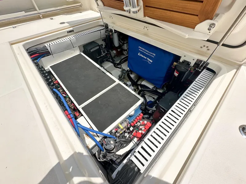 Slide: The Image of Engine compartment of a 2021 Boston Whaler 380 Outrage, showcasing detailed components and wiring. - 13