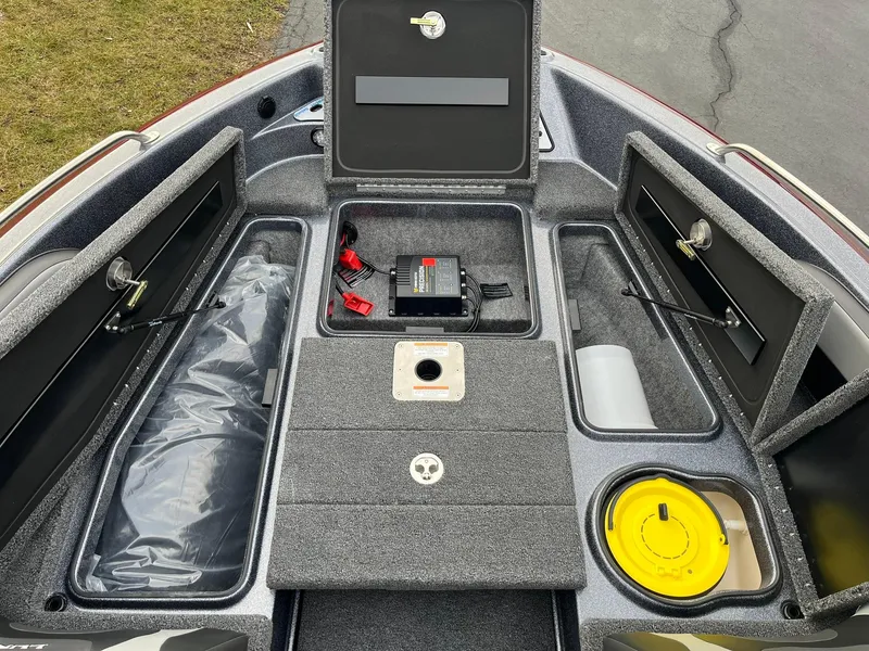 Slide: The Image of 2025 Lund 189 Tyee GL boat interior with storage compartments and battery. - 12
