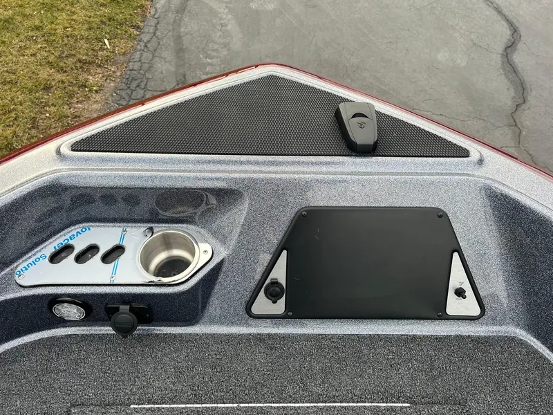 Slide: The Image of 2025 Lund 189 Tyee GL boat dashboard with cup holder and control panel. - 13