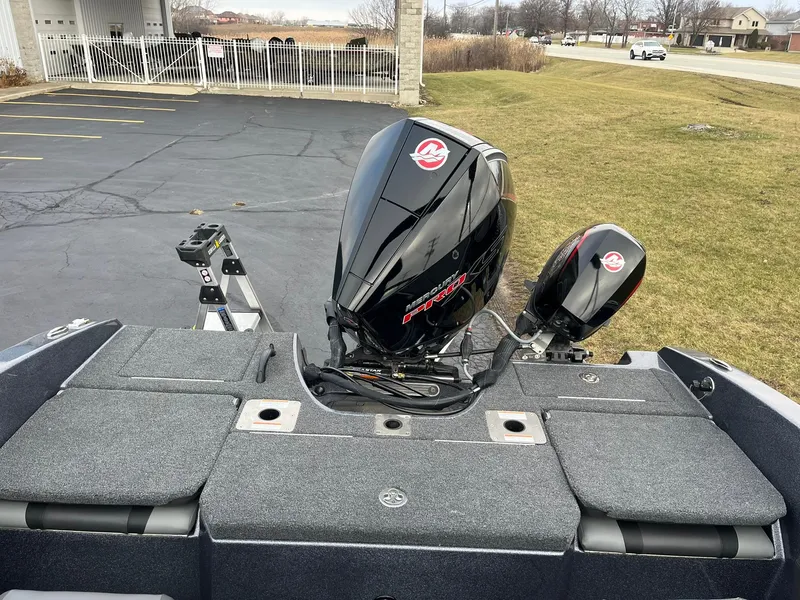 Slide: The Image of 2025 Lund 189 Tyee GL boat with powerful outboard motors in a parking lot. - 15