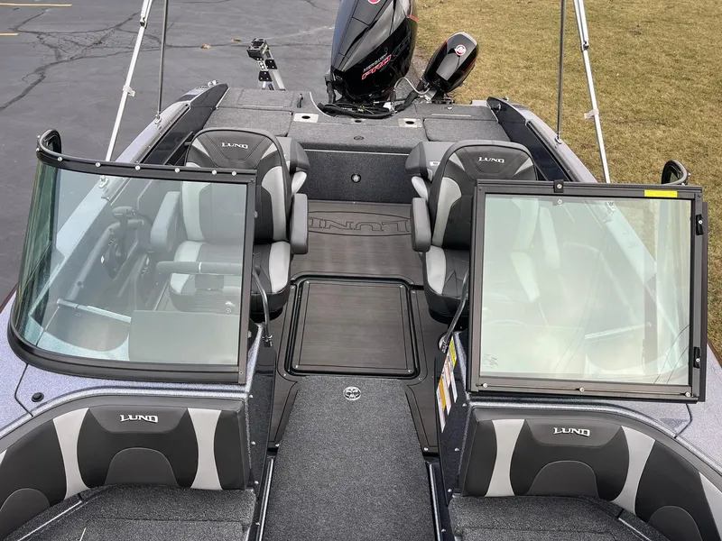 Slide: The Image of 2025 Lund 189 Tyee GL boat interior with seating and windshield. - 16