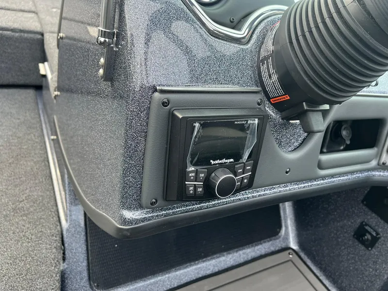 Slide: The Image of 2025 Lund 189 Tyee GL boat dashboard with Rockford Fosgate audio system. - 22