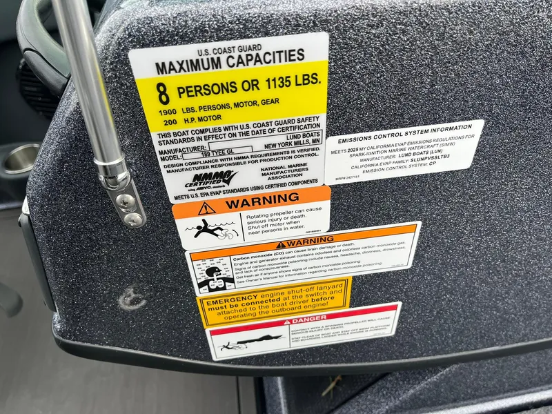 Slide: The Image of Capacity and safety labels on 2025 Lund 189 Tyee GL boat dashboard. - 23