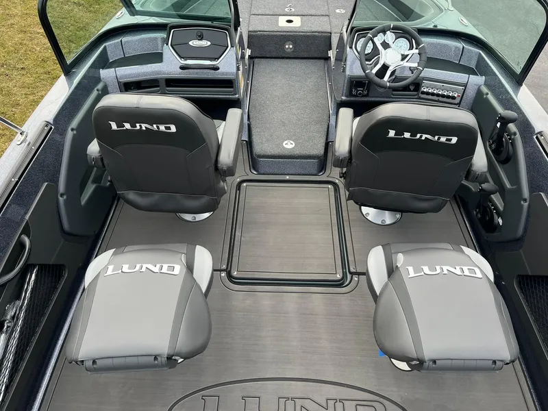 Slide: The Image of 2025 Lund 189 Tyee GL boat interior with four branded seats and steering console. - 6