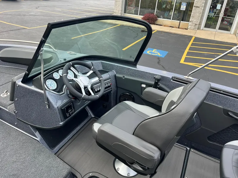 Slide: The Image of 2025 Lund 189 Tyee GL boat interior with steering wheel and seating. - 7