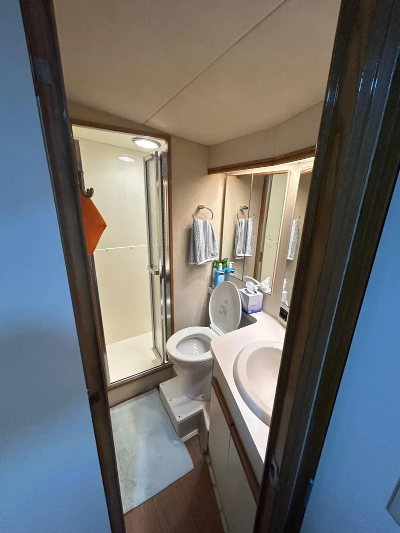 Slide: The Image of 1988 Bertram 43 Convertible yacht bathroom with shower, sink, and toilet. - 10
