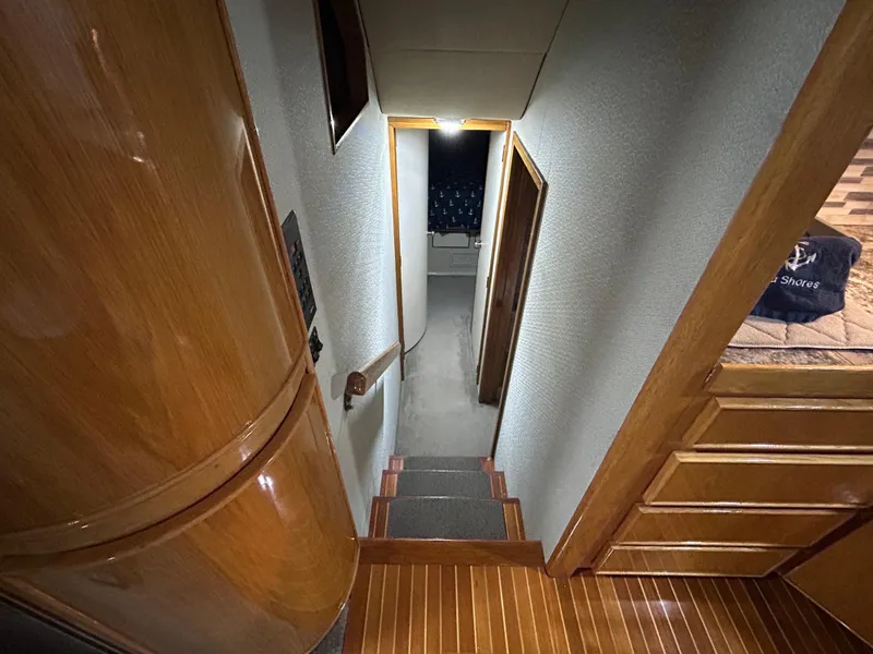 Slide: The Image of Interior staircase of 1988 Bertram 43 Convertible yacht with wooden finish. - 16