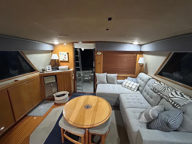 Slide: The Image of Interior of 1988 Bertram 43 Convertible yacht with cozy seating and wooden accents. - 18