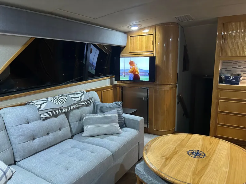 Slide: The Image of Interior of 1988 Bertram 43 Convertible yacht with cozy seating and TV. - 19