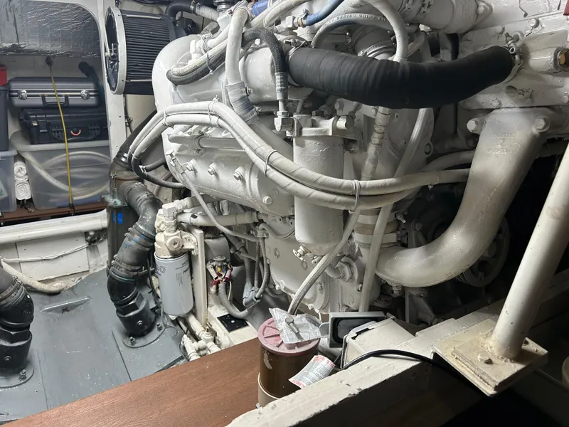 Slide: The Image of Engine room of 1988 Bertram 43 Convertible boat, showcasing detailed mechanical components. - 5