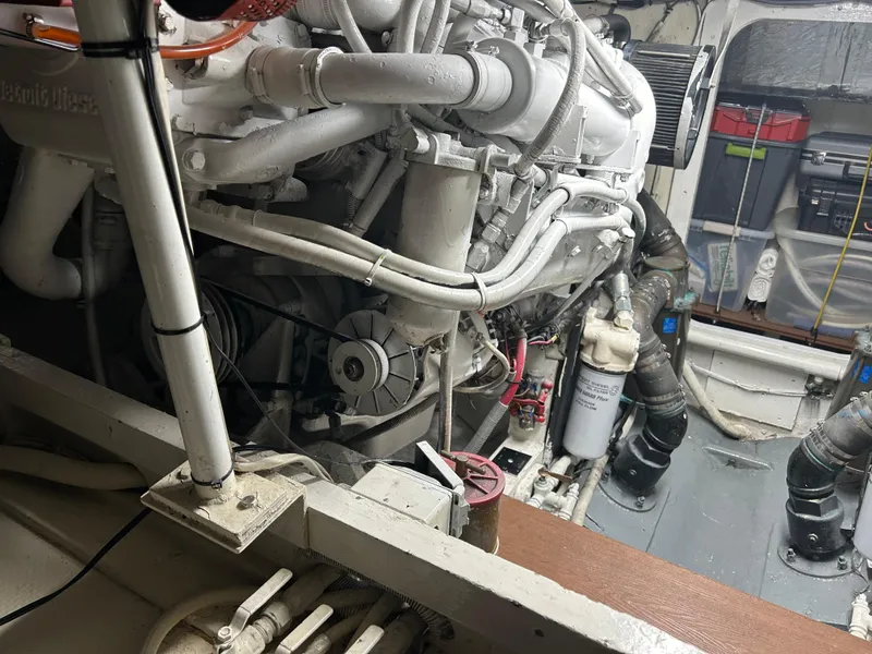 Slide: The Image of Engine room of a 1988 Bertram 43 Convertible yacht, showcasing detailed machinery. - 7
