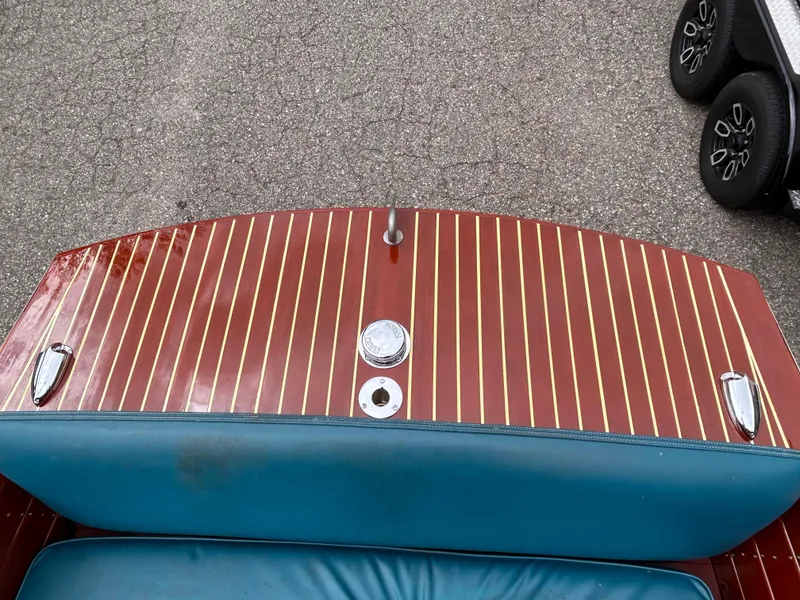 Slide: The Image of 1953 Chris-Craft 22 Sportsman boat with polished wood deck and blue seating. - 10
