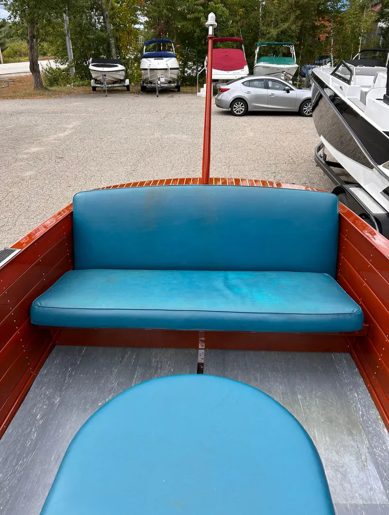 Slide: The Image of 1953 Chris-Craft 22 Sportsman boat interior with blue seating and wooden details. - 11