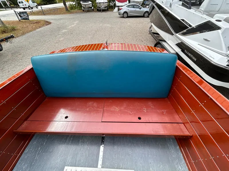 Slide: The Image of 1953 Chris-Craft 22 Sportsman boat interior with blue seat and wooden finish. - 12