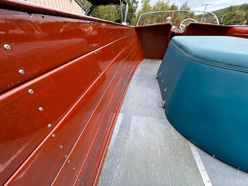 Slide: The Image of 1953 Chris-Craft 22 Sportsman boat interior with polished wood and blue seating. - 16