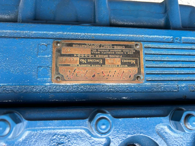 Slide: The Image of Close-up of a 1953 Chris-Craft 22 Sportsman engine plate, featuring model and engine details. - 22